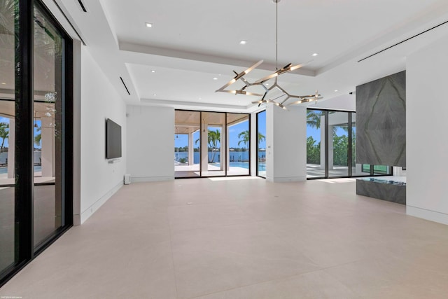 unfurnished living room featuring a raised ceiling