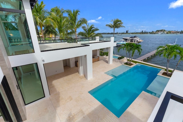 view of pool with a water view and a patio