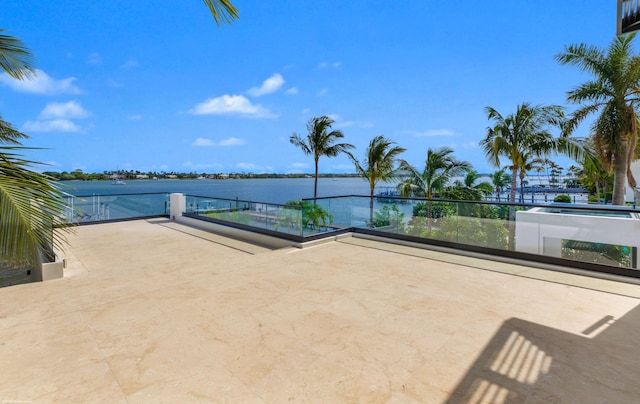 view of patio with a water view and a balcony