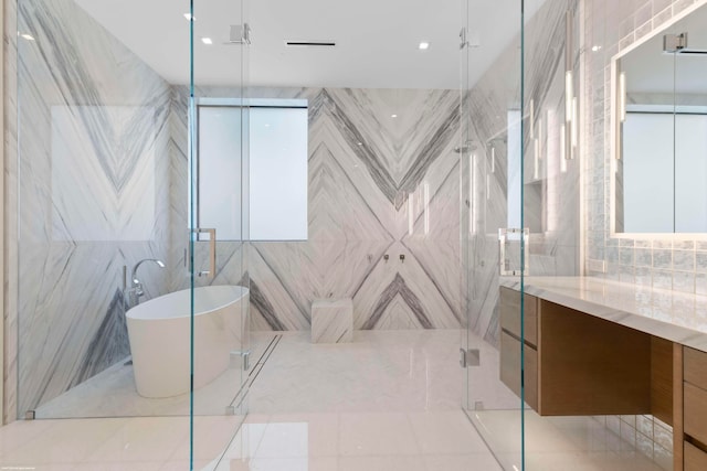 bathroom with vanity, tile walls, independent shower and bath, and tile patterned flooring