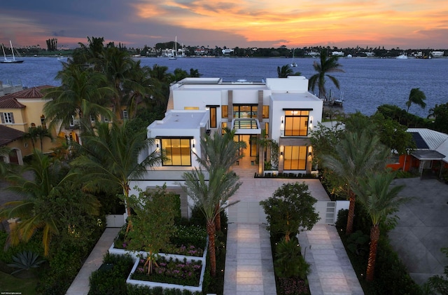 view of front of home featuring a water view and a balcony