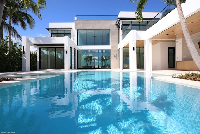 view of swimming pool featuring a patio area and ceiling fan