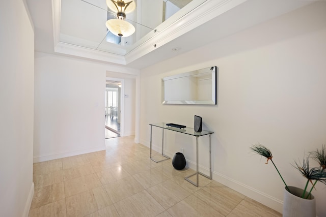 hallway featuring a raised ceiling and light tile floors