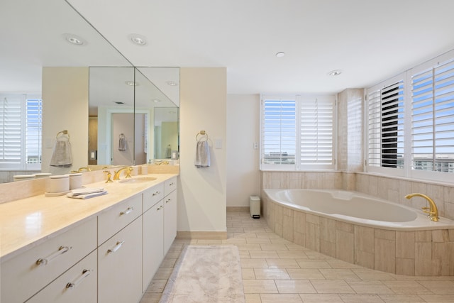 bathroom featuring tile floors, large vanity, and tiled bath