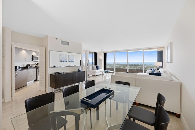 interior space with floor to ceiling windows and light tile floors