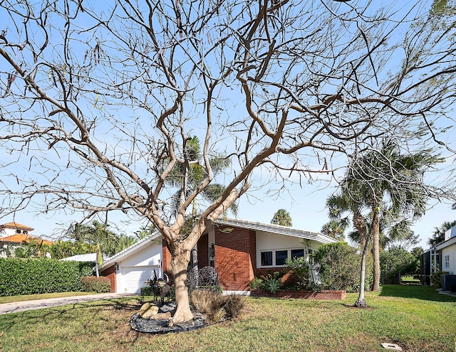 view of home's exterior with a garage and a lawn