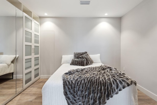 bedroom featuring light hardwood / wood-style flooring and a closet