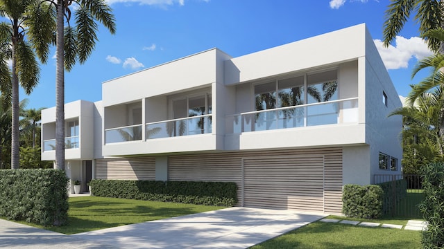 view of front of home featuring driveway, a front lawn, and stucco siding