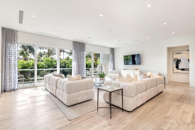 living area featuring light wood-style floors, visible vents, and recessed lighting