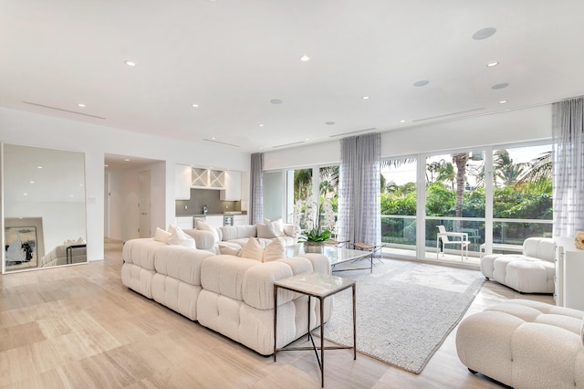 living room with light wood-style floors and recessed lighting