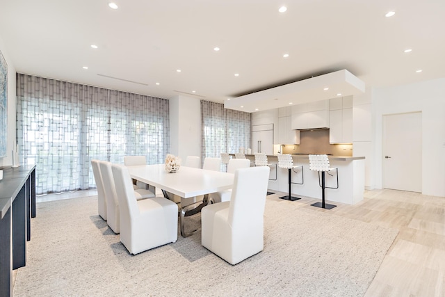 dining area with light wood-type flooring and recessed lighting