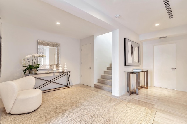 sitting room with stairway, visible vents, and recessed lighting