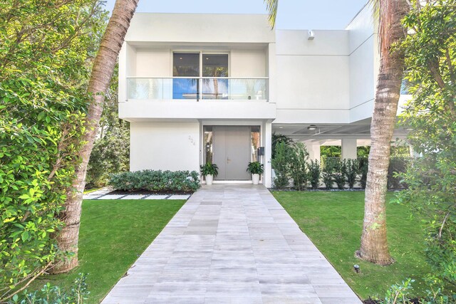 exterior space with a carport and a front yard