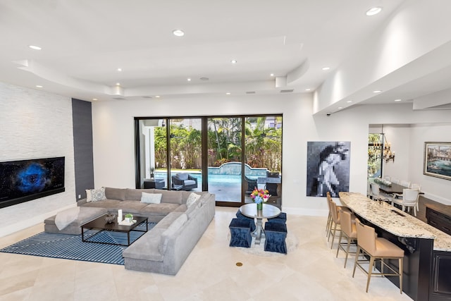 tiled living room with a tray ceiling