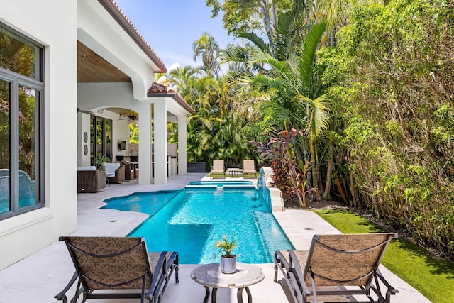 view of pool featuring a patio and ceiling fan