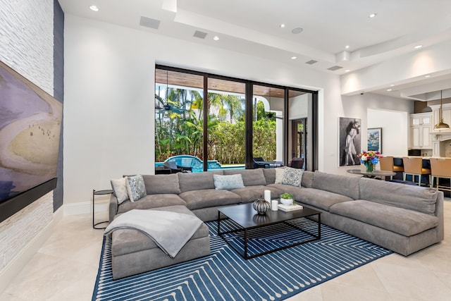 tiled living room with a raised ceiling