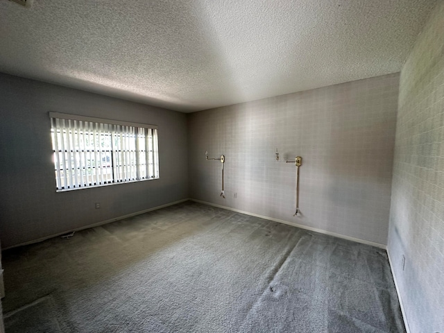 carpeted spare room with a textured ceiling