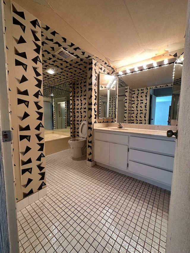 bathroom featuring tile patterned flooring, toilet, and vanity