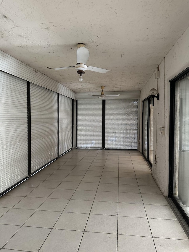 interior space featuring light tile patterned floors and ceiling fan