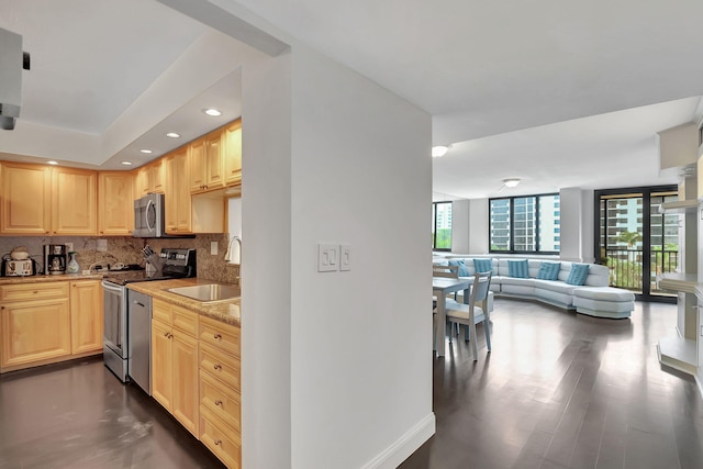 kitchen with decorative backsplash, light brown cabinets, sink, and appliances with stainless steel finishes