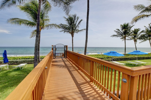 surrounding community featuring a view of the beach and a water view