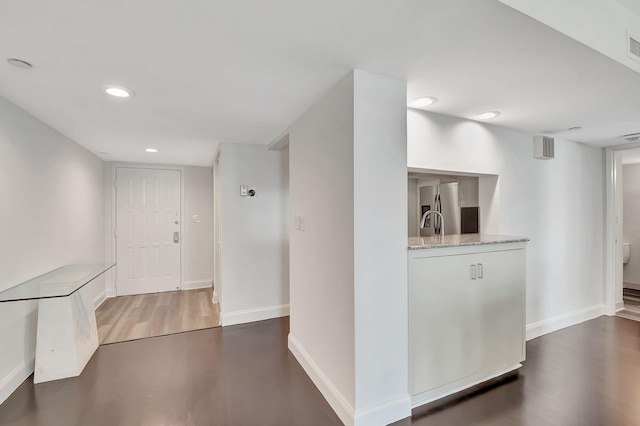 hallway with dark wood-type flooring