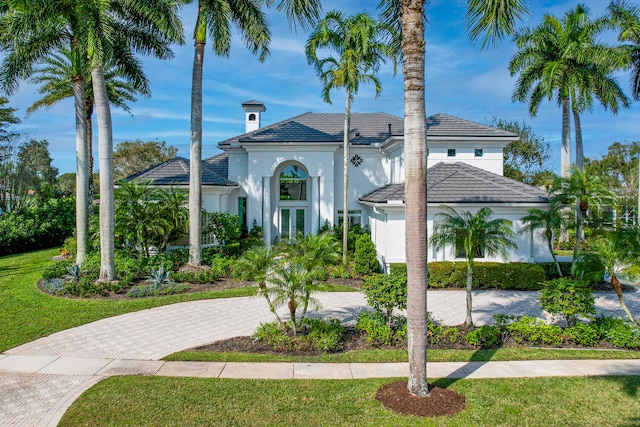 mediterranean / spanish-style home with a front yard