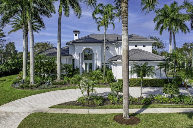 view of front of home with a front yard and french doors