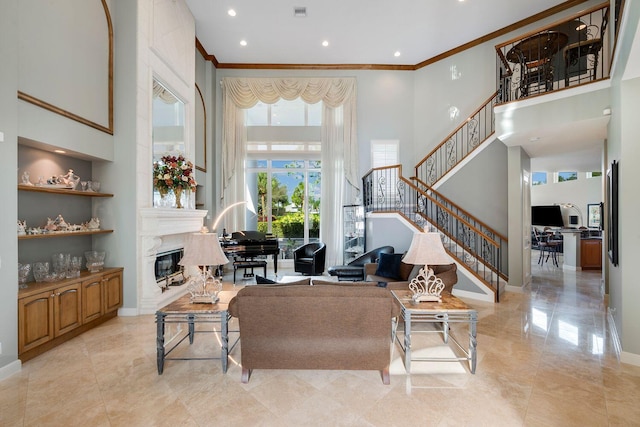 living room with crown molding and a high ceiling