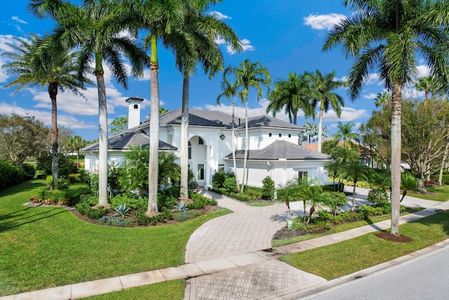 mediterranean / spanish-style home with a front lawn