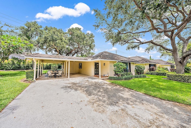 ranch-style house with a front yard and a carport