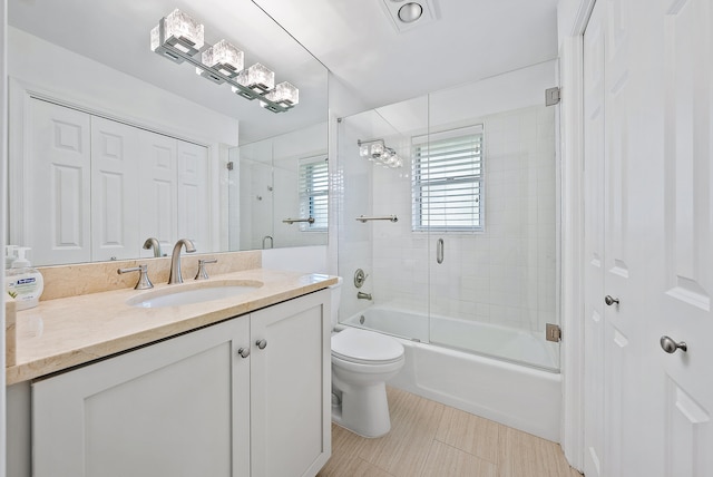 full bathroom with toilet, combined bath / shower with glass door, and vanity