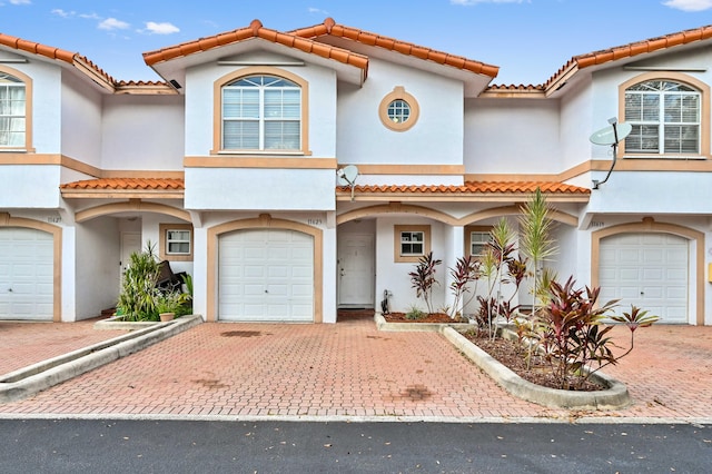 mediterranean / spanish house featuring a garage