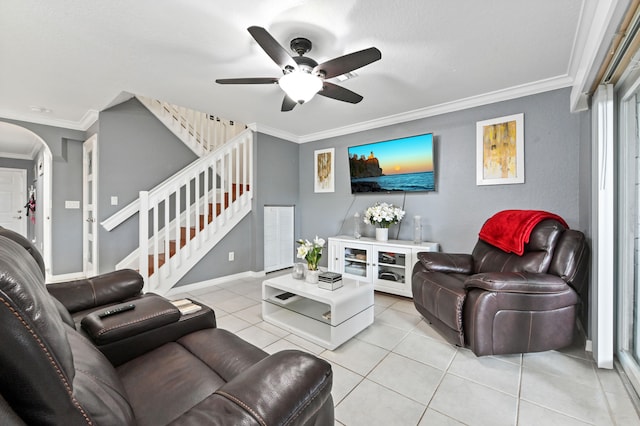 tiled living room featuring ornamental molding and ceiling fan