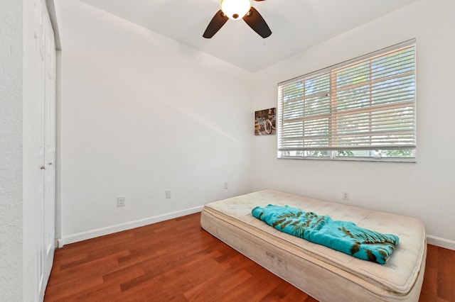 bedroom with ceiling fan and dark hardwood / wood-style flooring