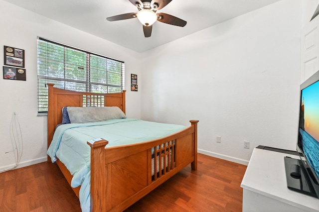 bedroom featuring ceiling fan and dark hardwood / wood-style flooring