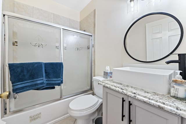 full bathroom with toilet, combined bath / shower with glass door, vanity, and tile patterned floors