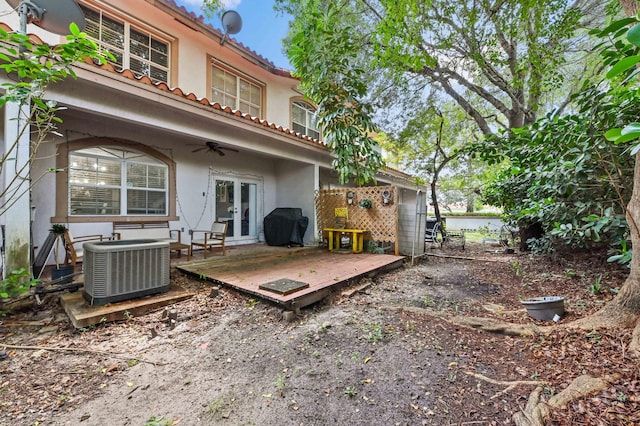 rear view of house with french doors, cooling unit, and a deck