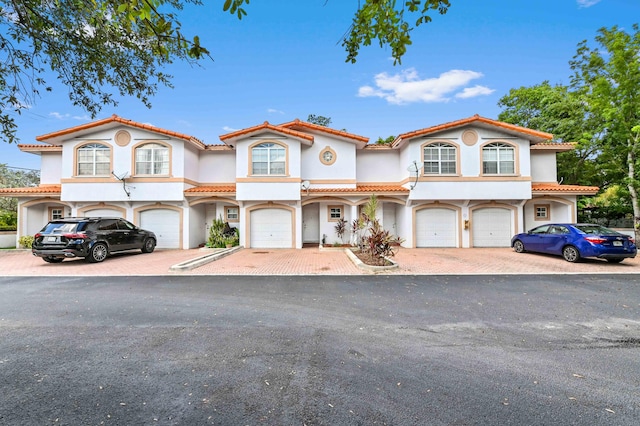 mediterranean / spanish-style home with a garage