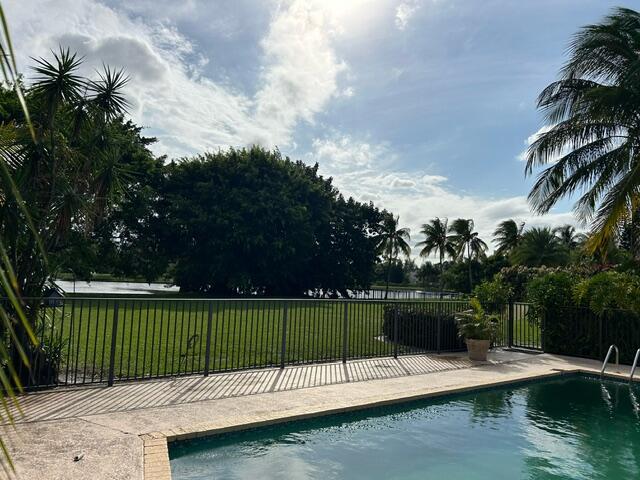 view of pool with a patio area and a yard