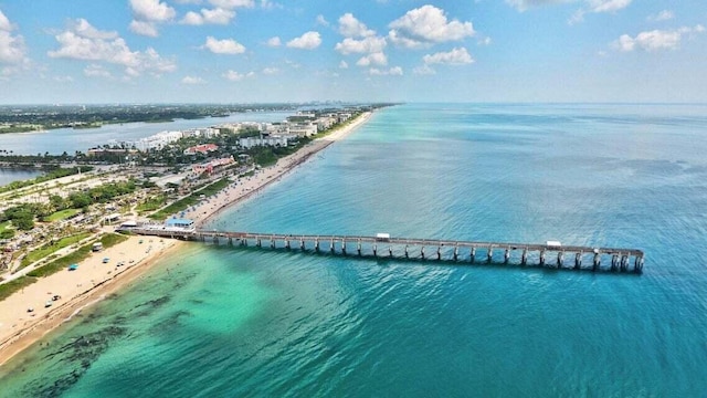 birds eye view of property featuring a water view and a beach view