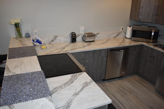 kitchen featuring appliances with stainless steel finishes and dark brown cabinets