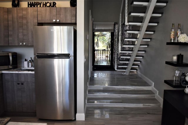 kitchen with stainless steel appliances, wood-type flooring, and sink