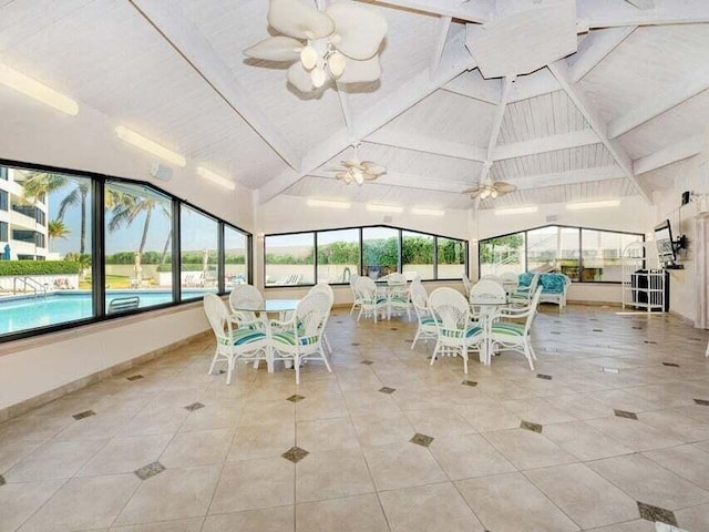 unfurnished sunroom with lofted ceiling with beams and ceiling fan