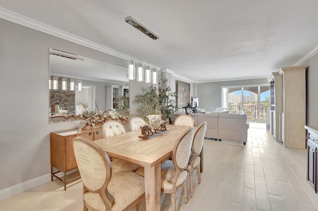 dining area with light hardwood / wood-style floors and crown molding