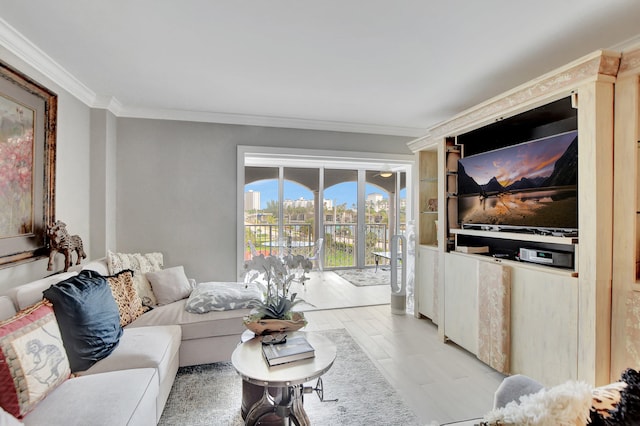 living room with ornamental molding and light hardwood / wood-style flooring