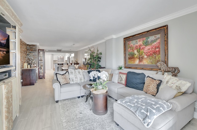 living room with ornamental molding and light hardwood / wood-style flooring