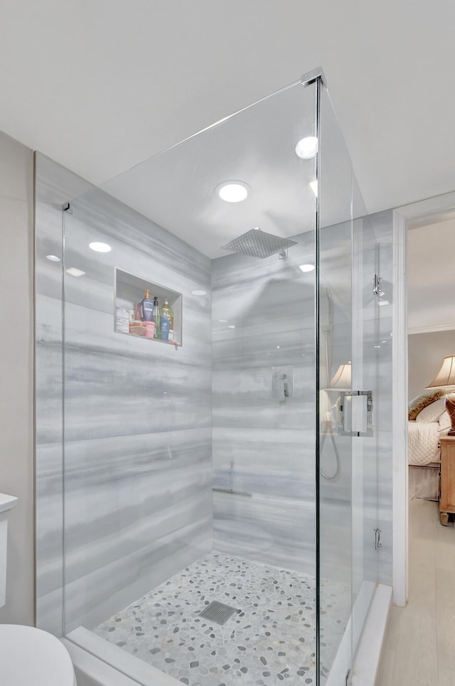 bathroom with an enclosed shower and toilet