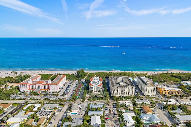 drone / aerial view featuring a beach view and a water view