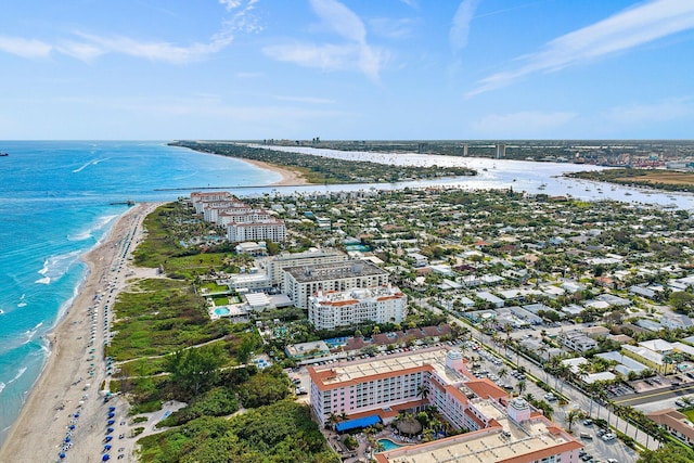 birds eye view of property featuring a water view and a beach view